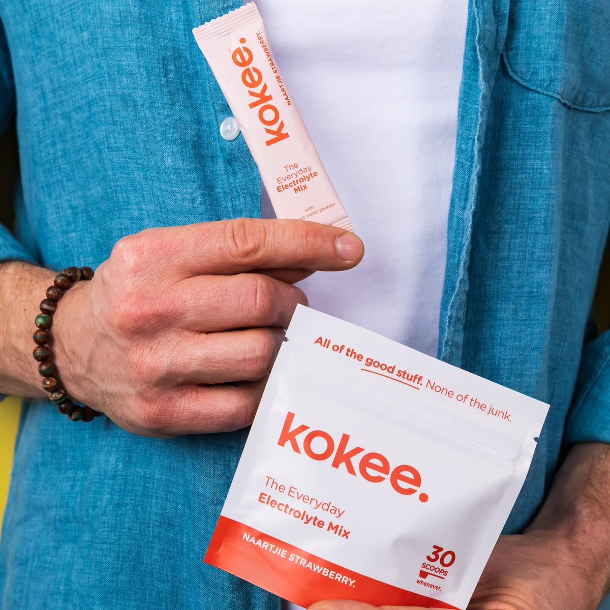 Hand taking a Kokee sachet out of an open Kokee pouch